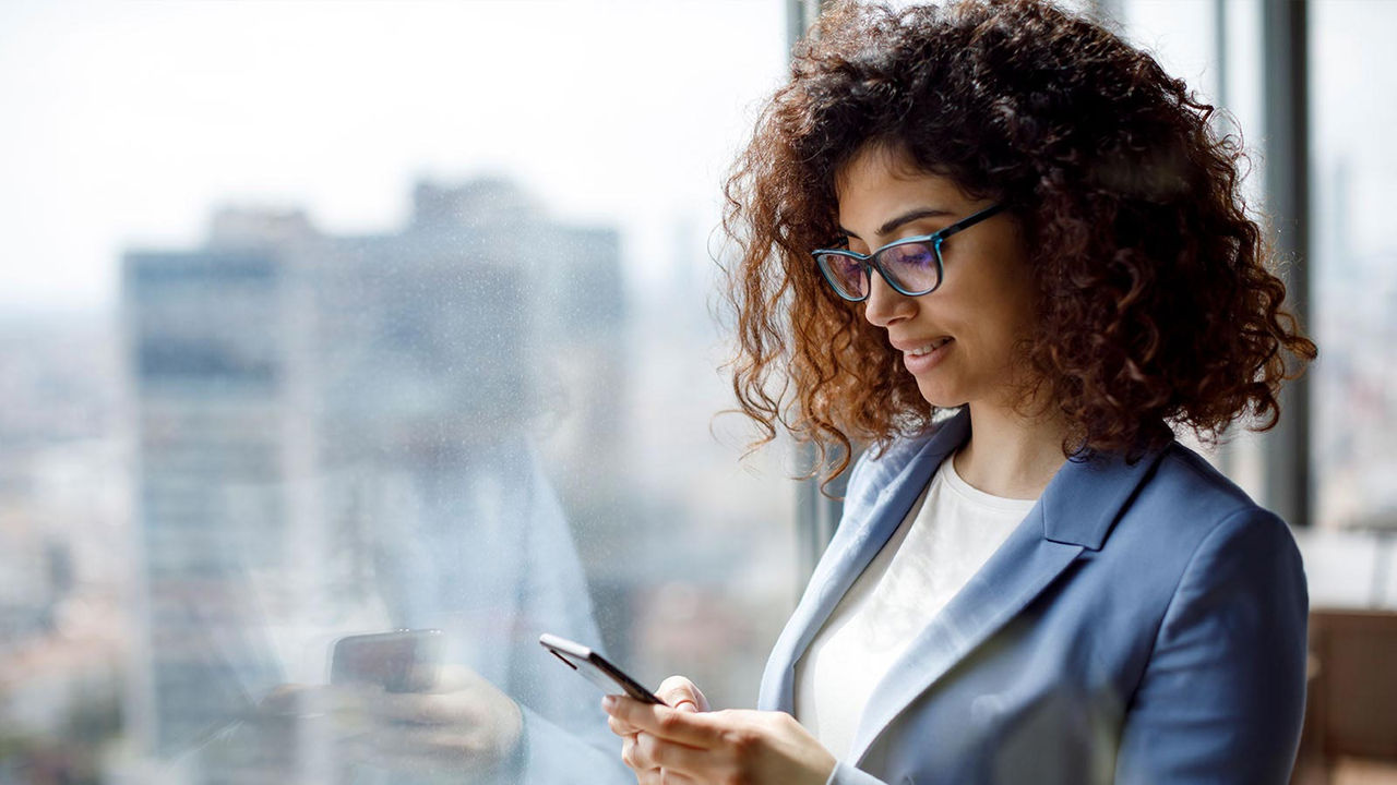 Business woman looking at phone