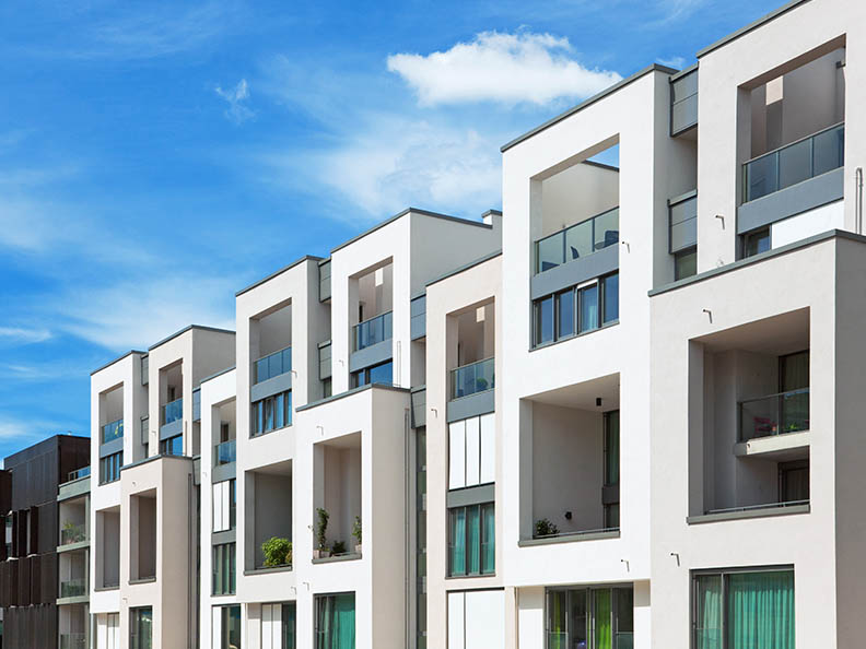 Apartment block with blue sky in background