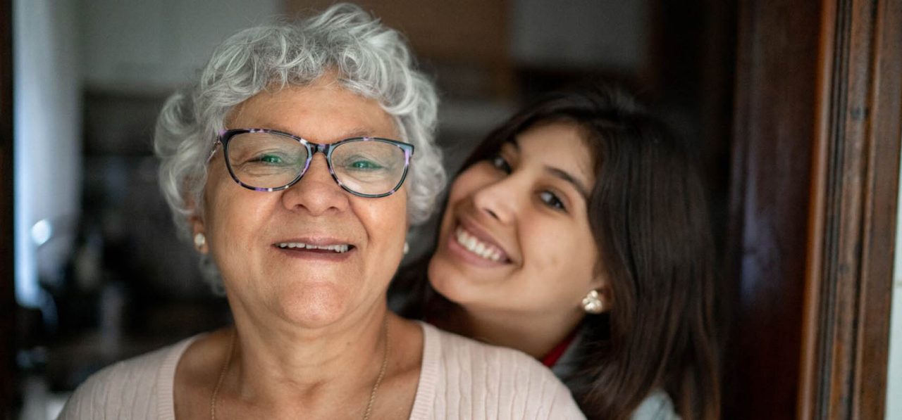 Portrait of grandmother and granddaughter at home