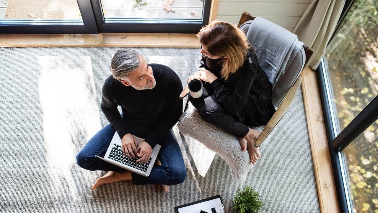 Businesswoman checking plan with laptop at home office.