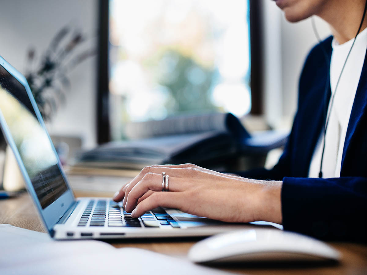 Businesswoman checking plan with laptop at home office.