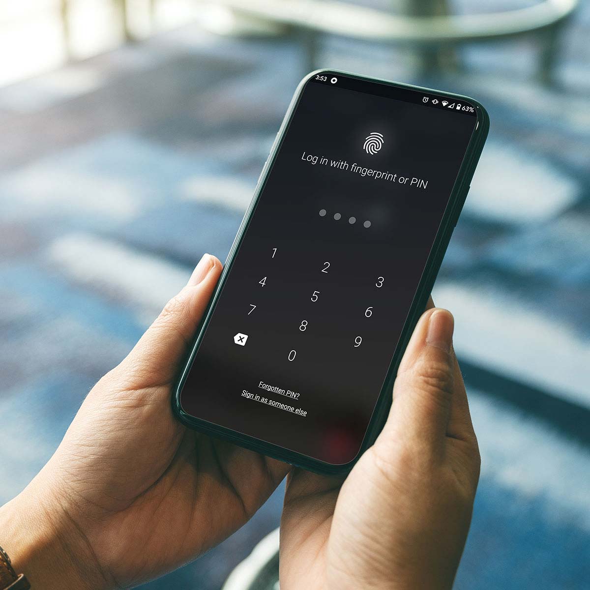 A close up shot of a hand holding a phone with the Macquarie bank app open