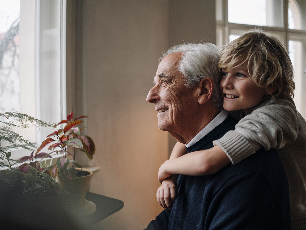 grandfather and grandson looking out window
