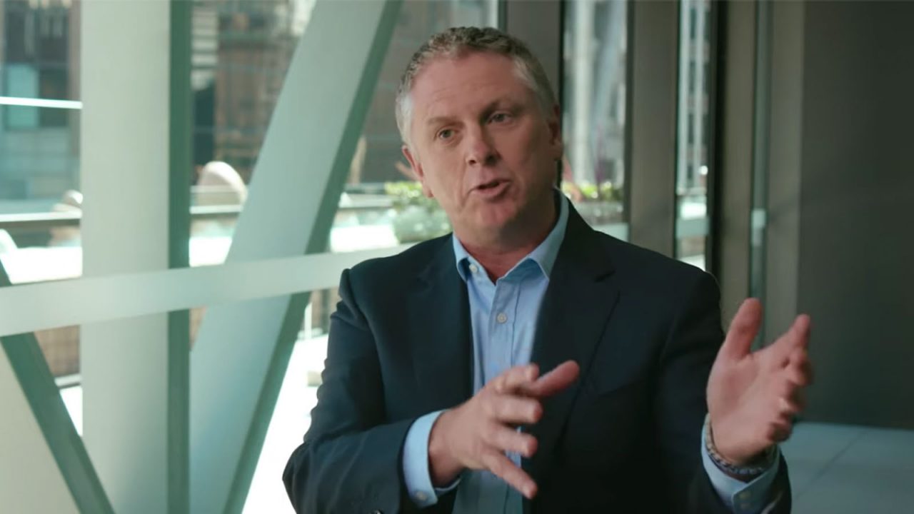 man in business suit talking to camera