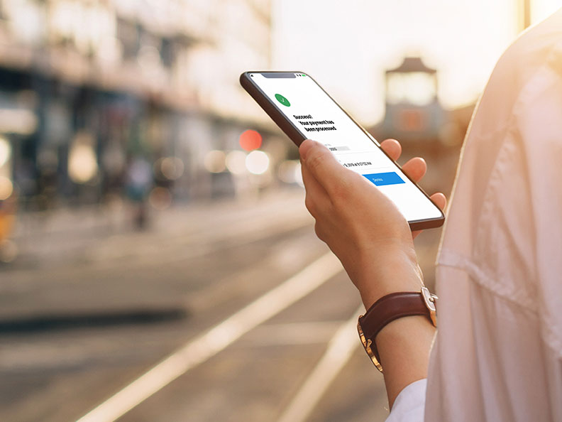 Hand holding a phone outside with the Macquarie authenticator app open